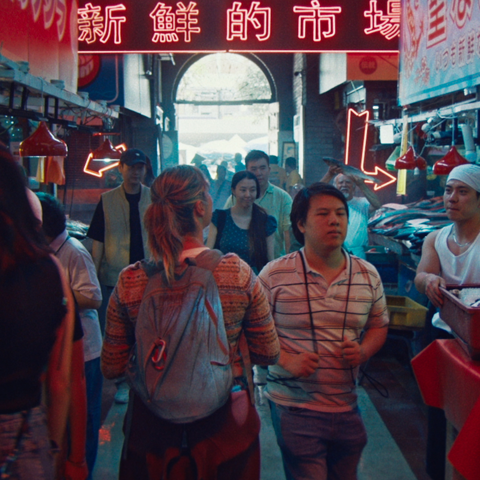 People walking down a busy street with vendors